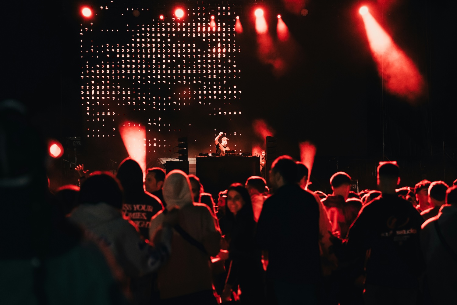 Crowd and stage lights in a large club venue